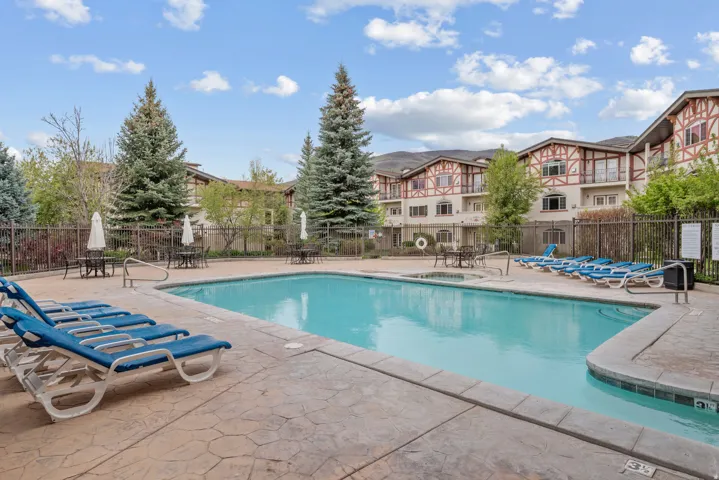 Swimming pool with concrete decking and adjacent spa