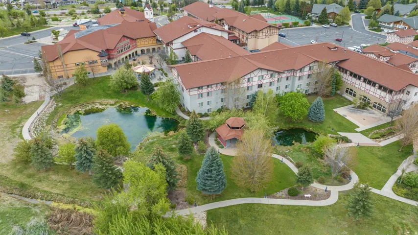 Expansive grounds featuring multiple ponds, mature trees, manicured lawns, a gazebo, and winding pathways