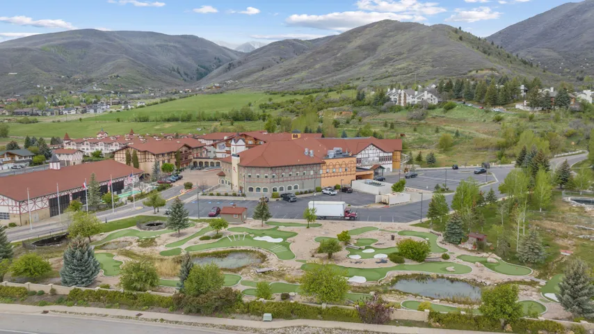 Expansive grounds featuring a miniature golf course with water features and mature landscaping