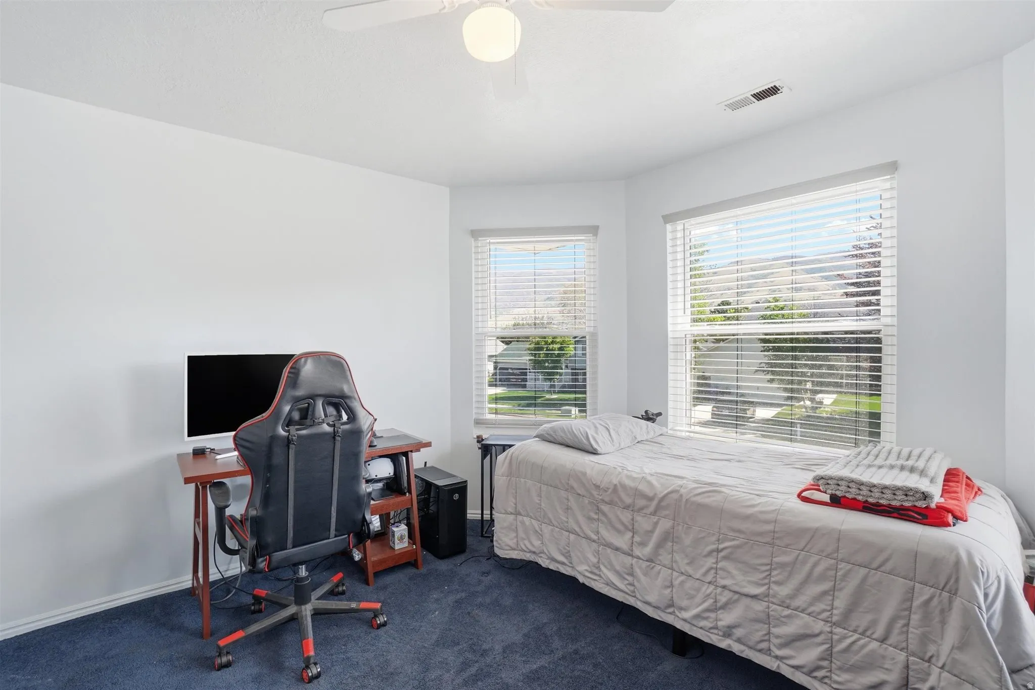 White walls with blue carpet flooring