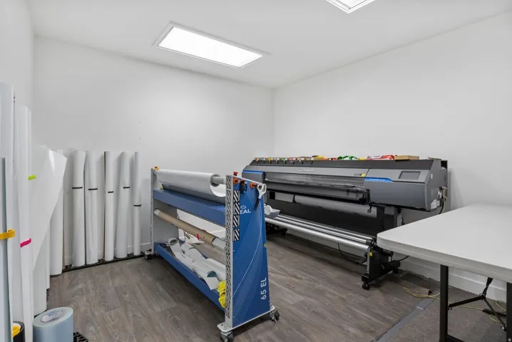 White walls with recessed ceiling lighting and wood-finish flooring
