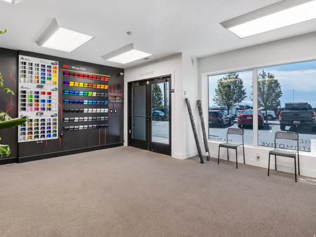 Commercial space featuring neutral-toned carpeting, recessed lighting, and a large display wall