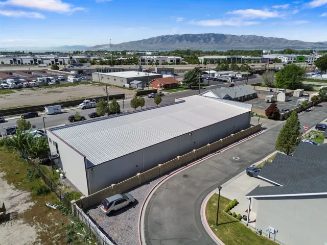 Expansive commercial building featuring a metal roof and light-colored siding