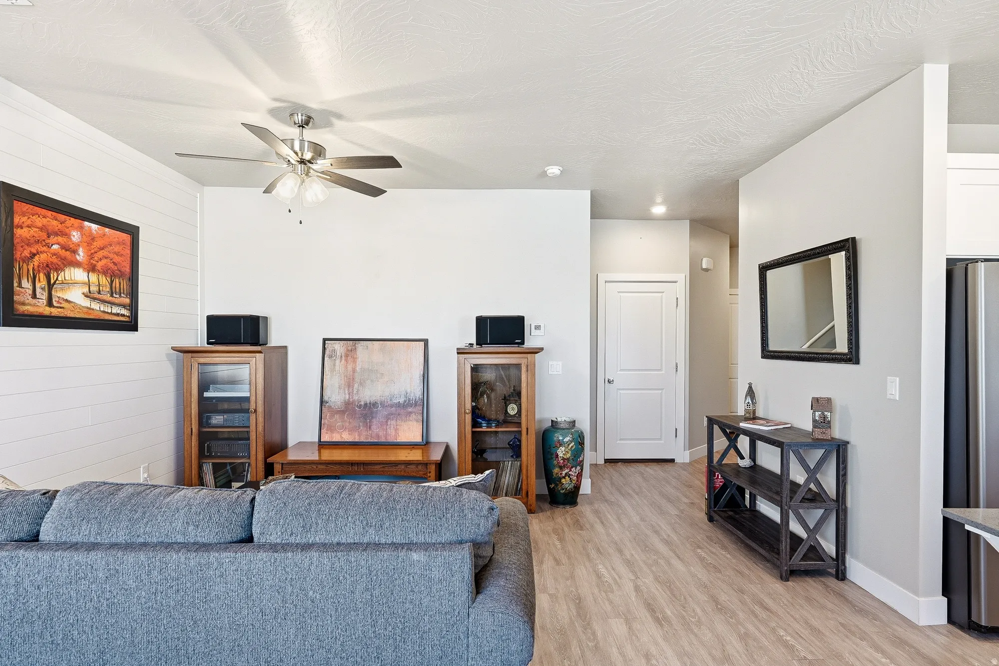 Open-concept living area featuring wood-finish flooring, recessed lighting, and a ceiling fan
