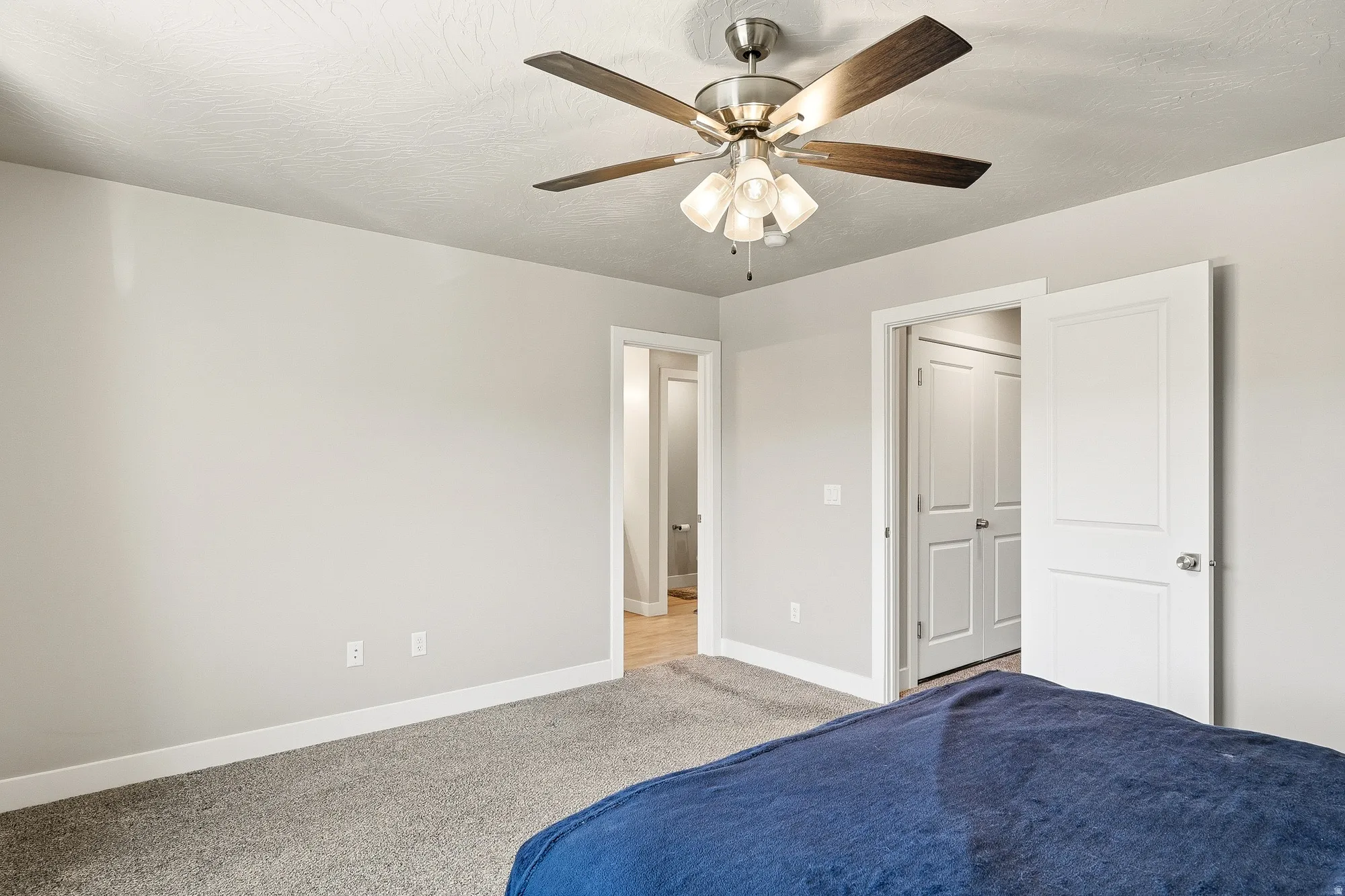 Bedroom featuring neutral gray walls, plush gray carpeting, and white baseboards