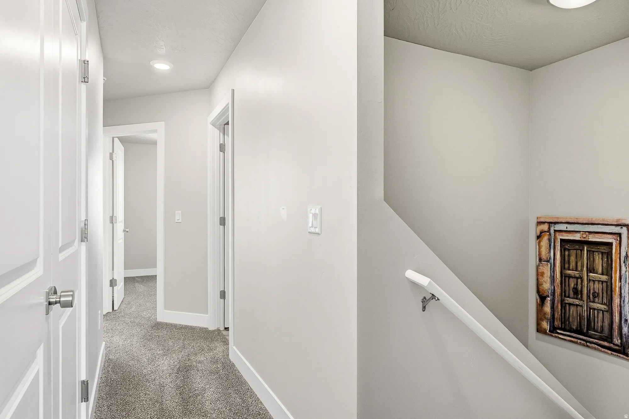 Hallway with recessed lighting, light gray wall paint, and gray carpet flooring