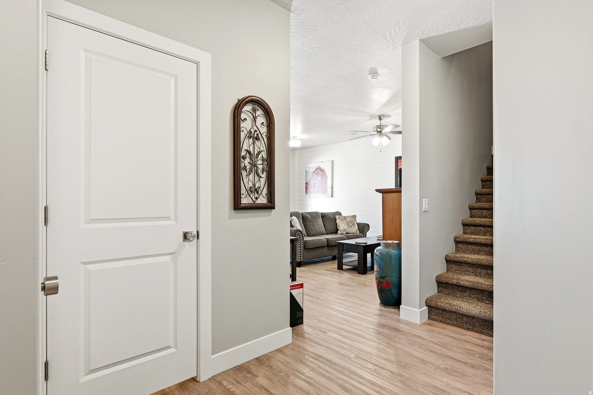 Wood-finish flooring throughout the main living areas, complemented by a carpeted staircase