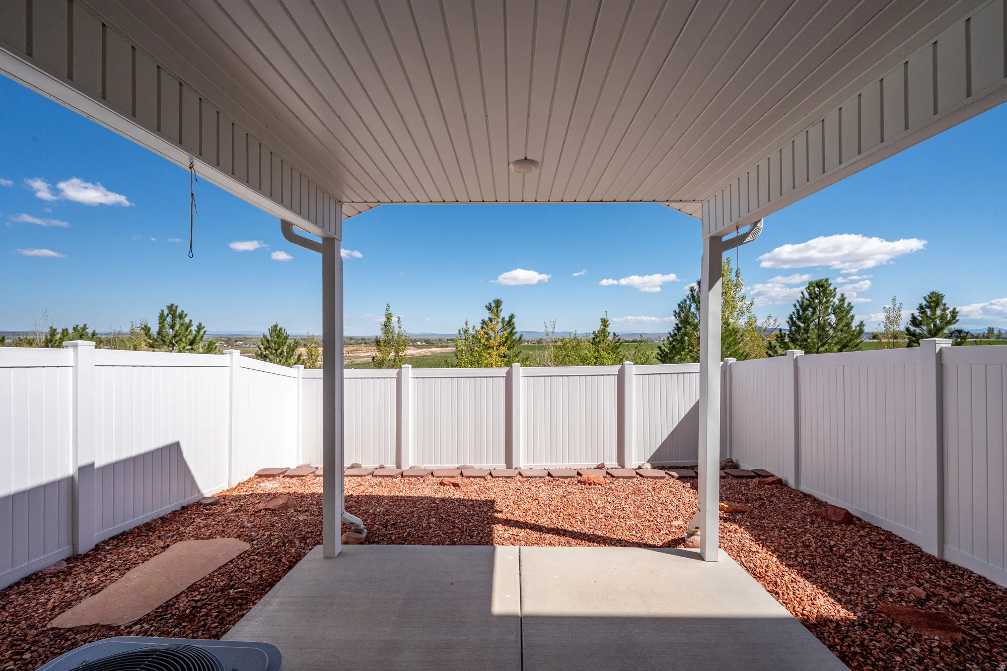 Covered patio featuring a concrete slab and a beadboard ceiling