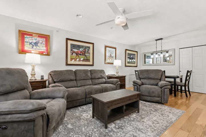 Living area with wood finished floors and ceiling fan