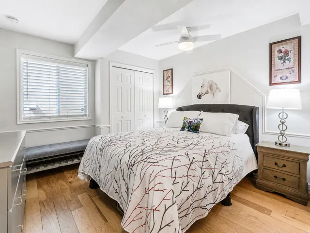 Bedroom featuring a closet, hardwood / wood-style flooring, and a ceiling fan