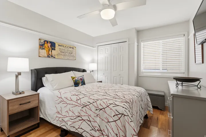 Bedroom featuring wood finished floors, a closet, and ceiling fan