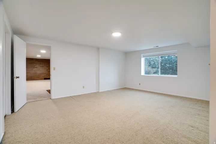 Carpeted room featuring a white interior and recessed lighting