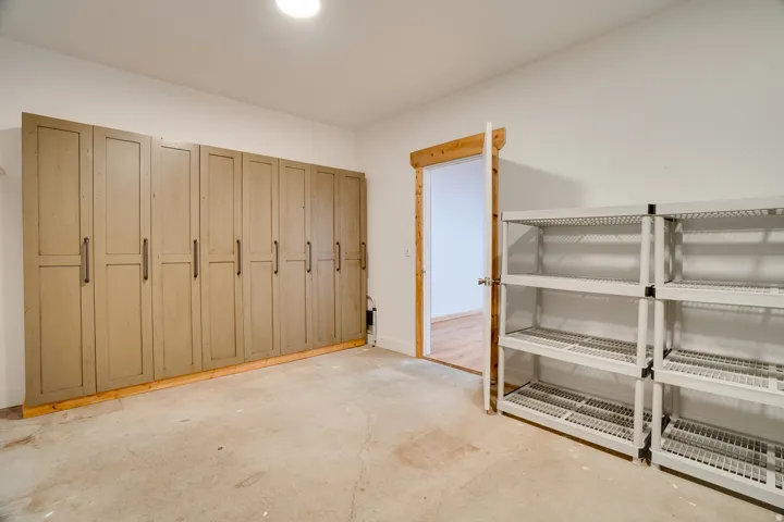 Room featuring a full wall of built-in cabinetry with panel doors and dark hardware