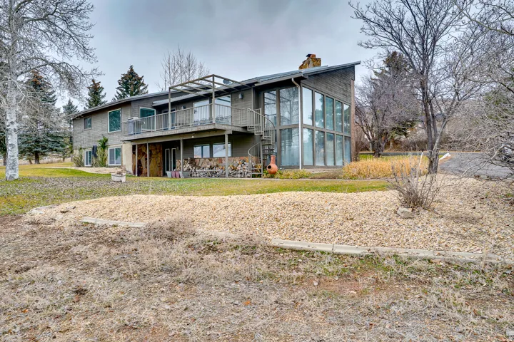 Multi-level residence featuring a prominent glass wall facade