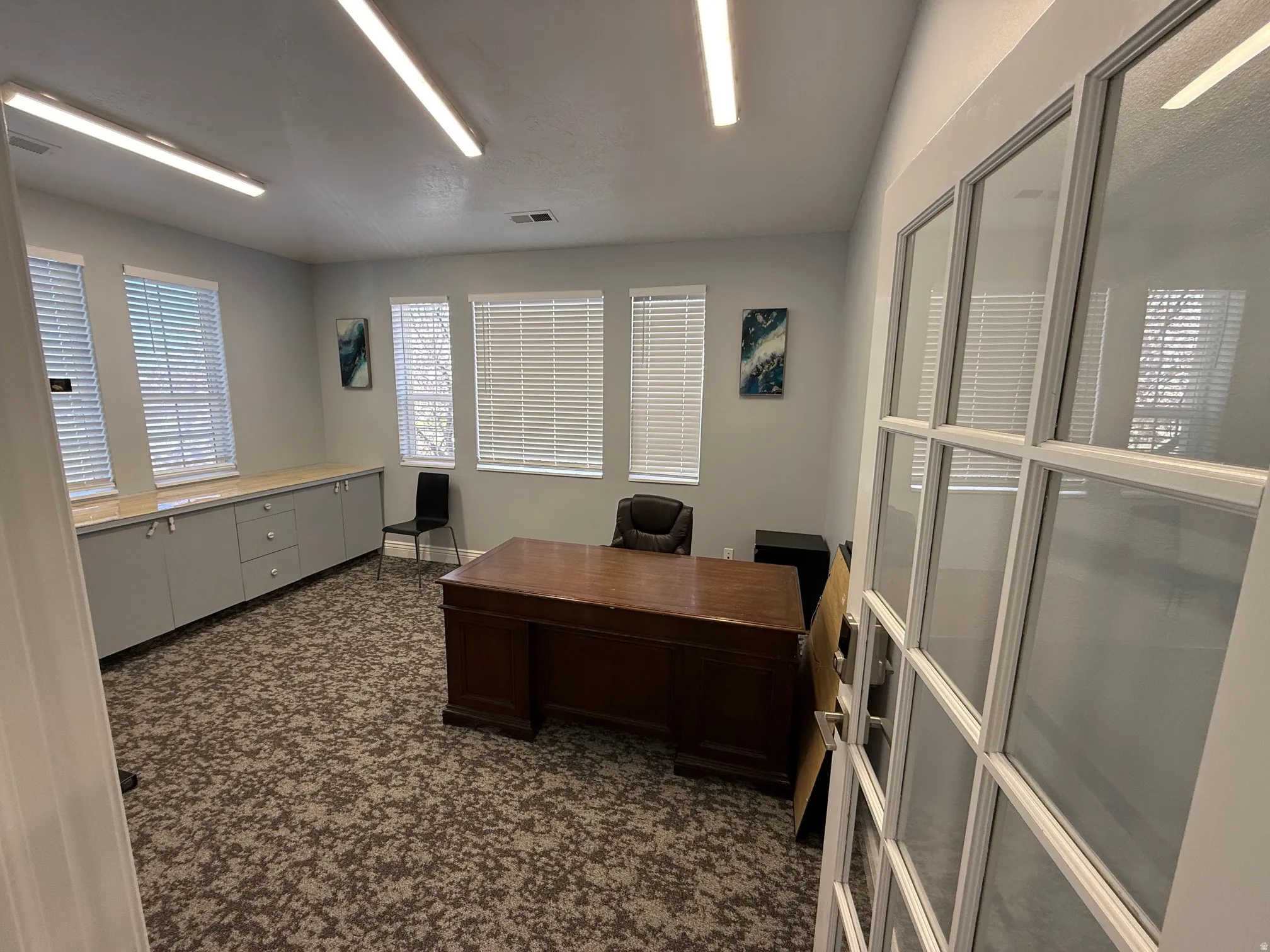 Room featuring patterned carpet flooring and track lighting