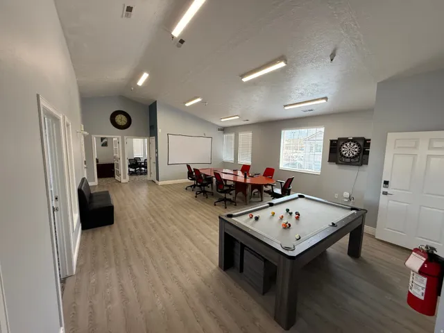 Spacious multi-purpose room featuring wood-finish flooring and a vaulted ceiling