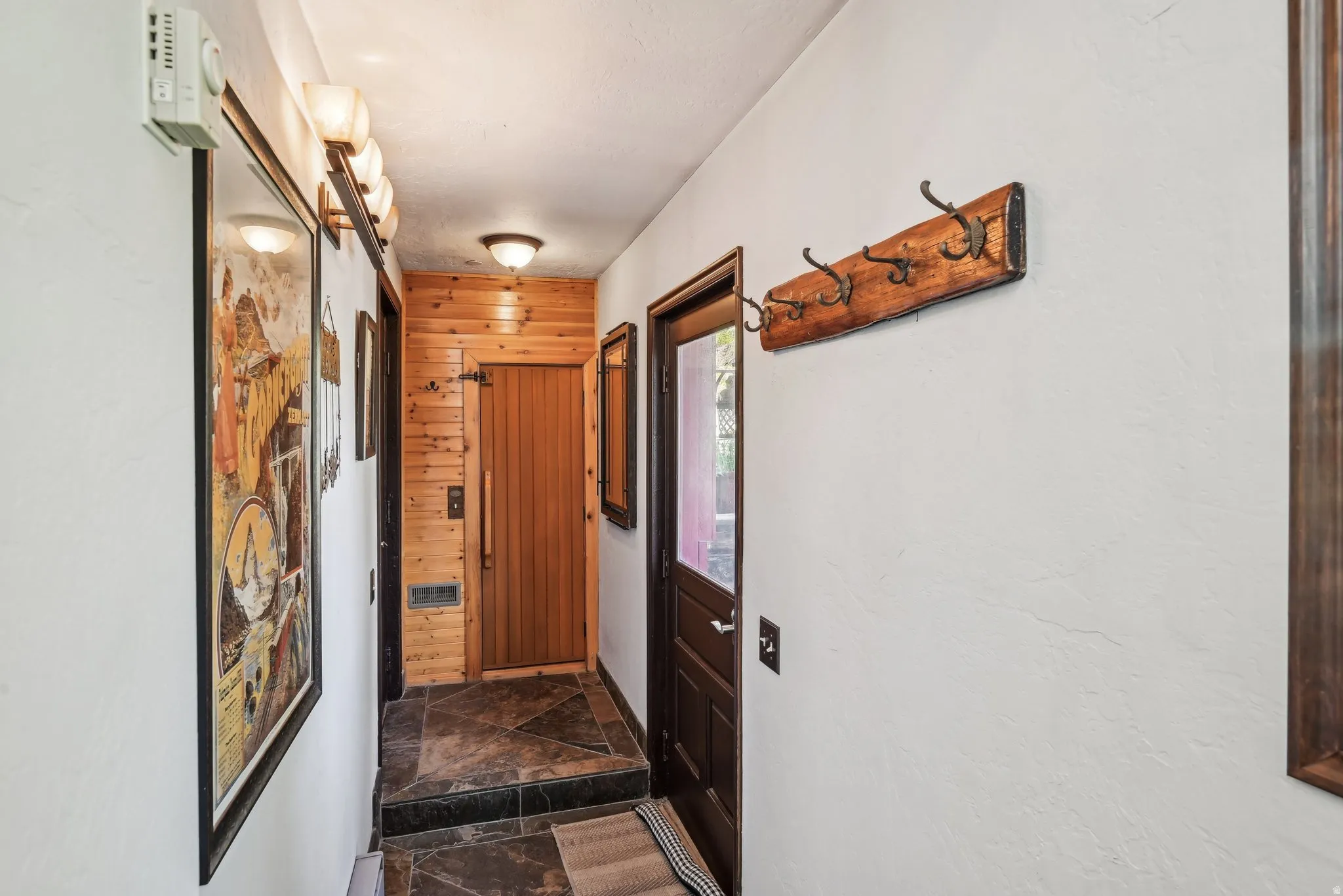 Doorway featuring stone tile floors