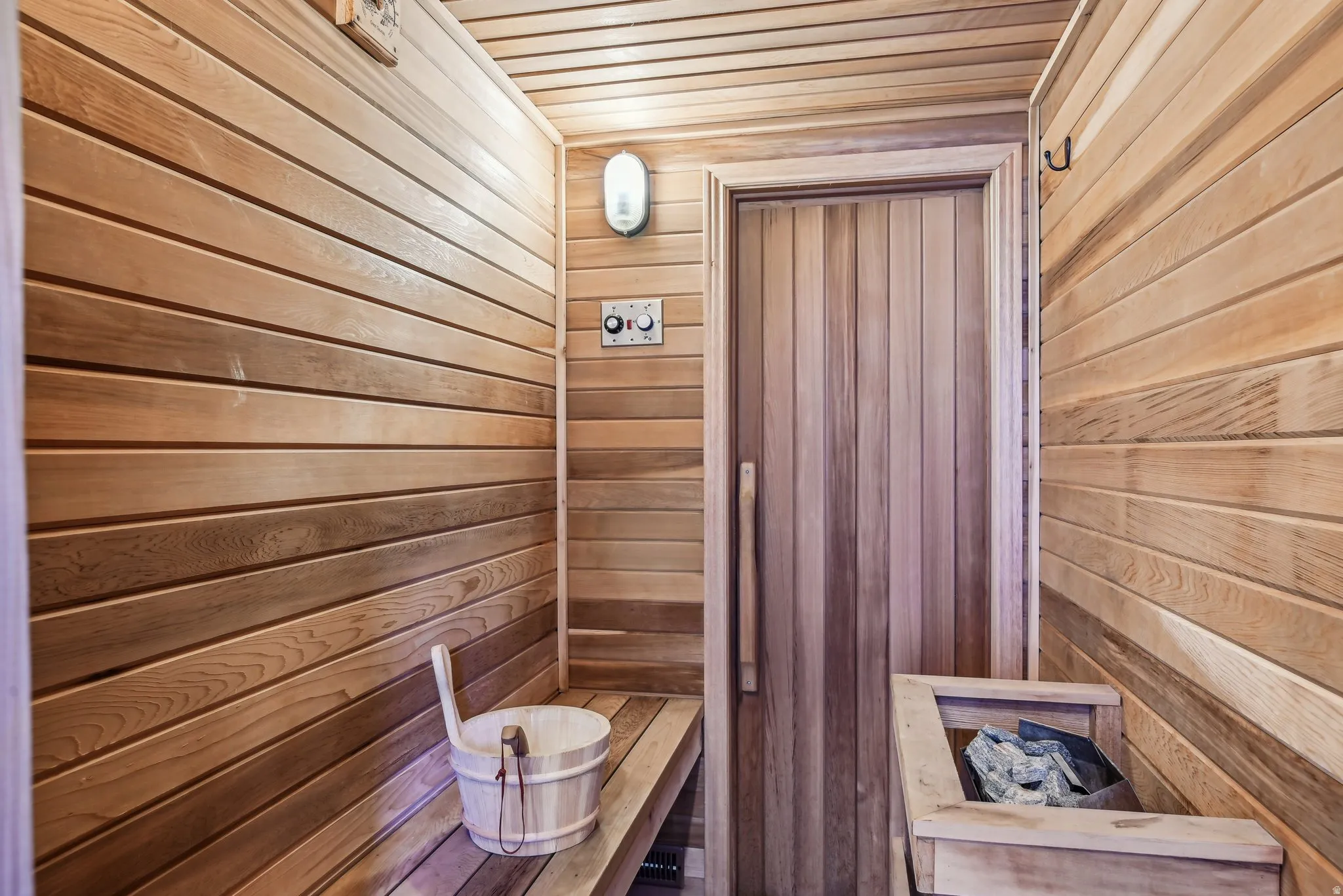 Relaxing sauna / steam room with wooden walls and wooden ceiling