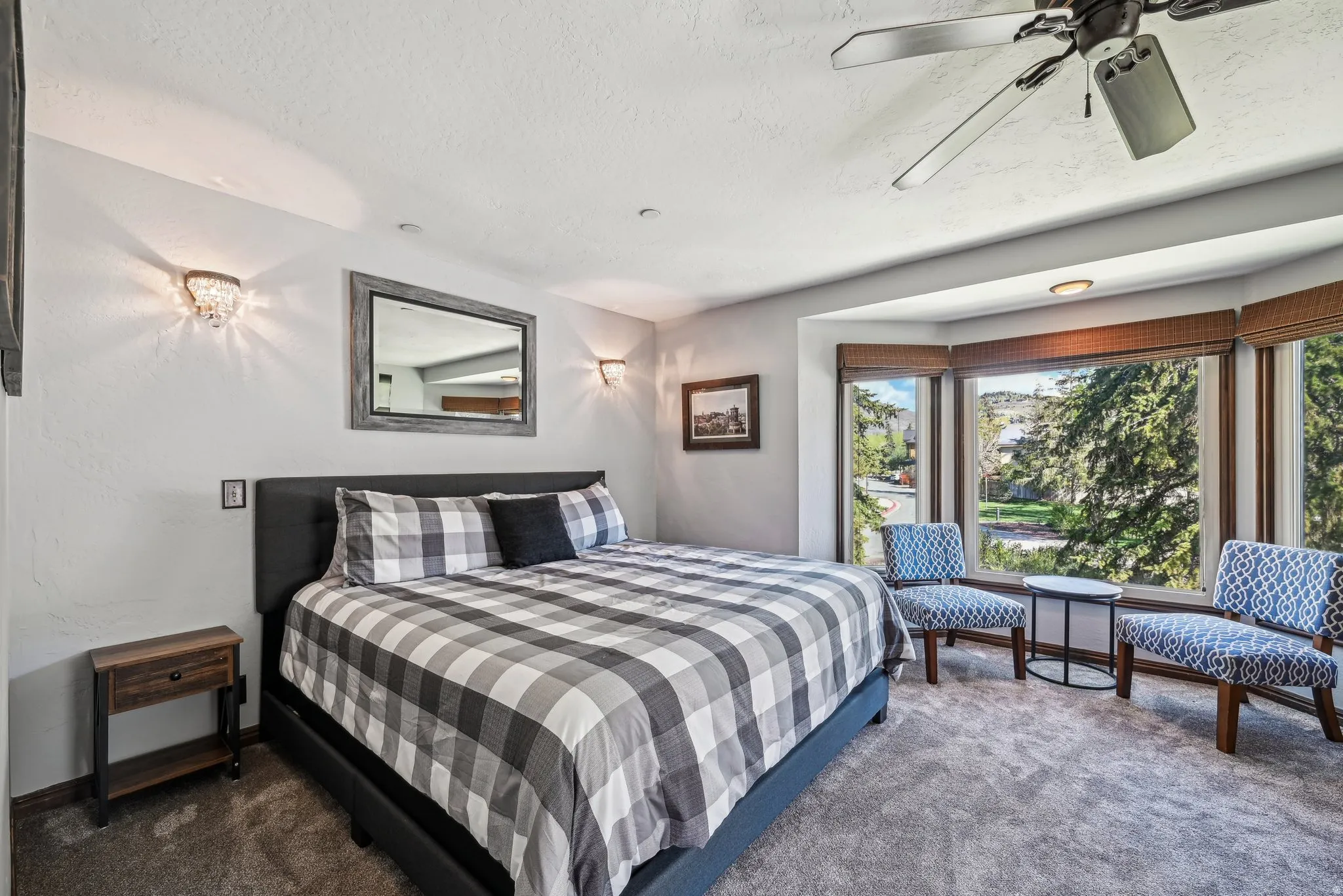 Bedroom featuring carpet, a ceiling fan, and a textured ceiling