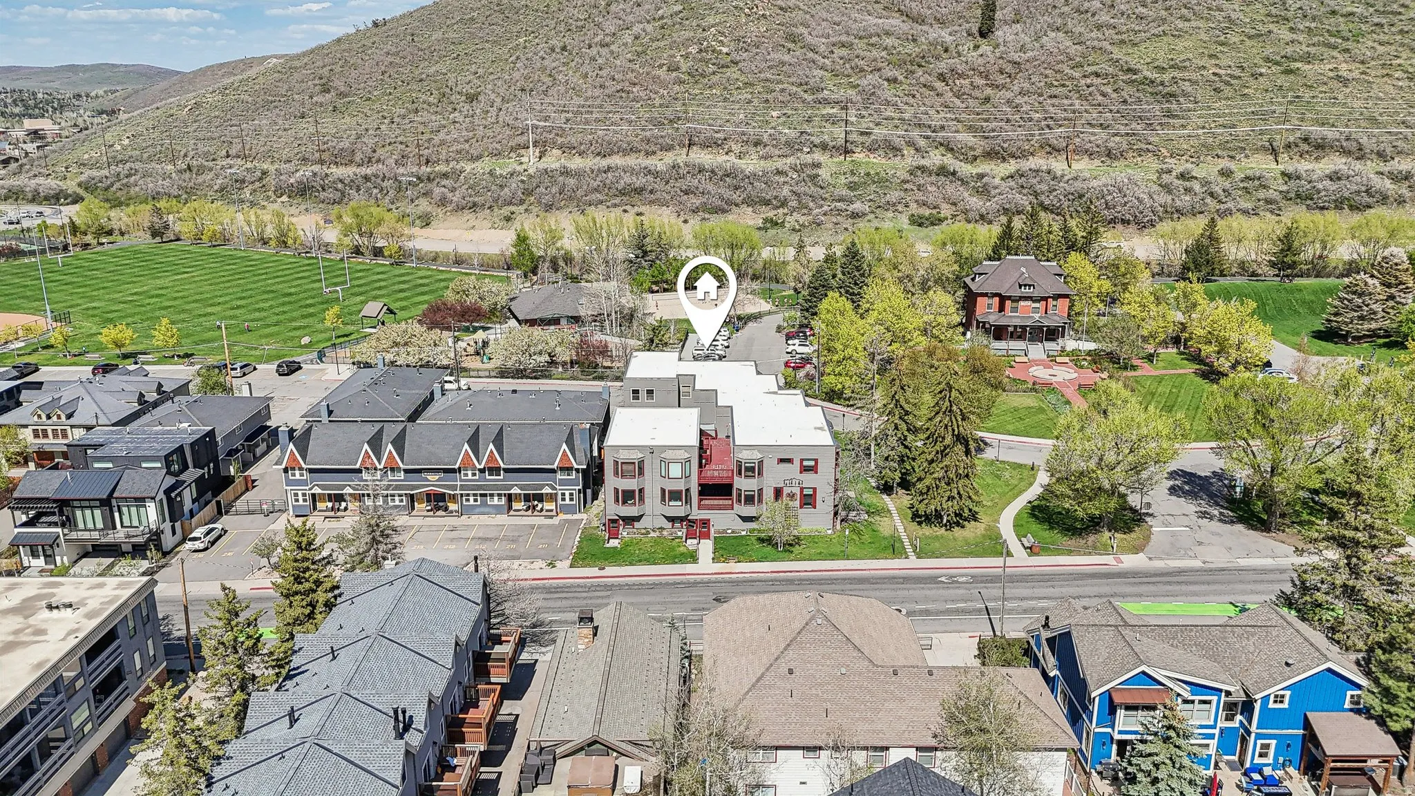 Aerial perspective of suburban area with a mountainous background
