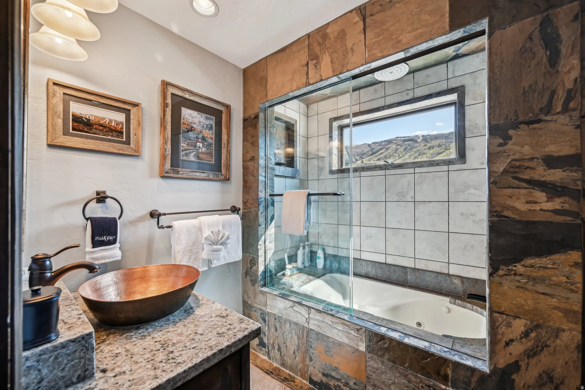 Bathroom featuring a combined bath / shower with jetted tub and vanity