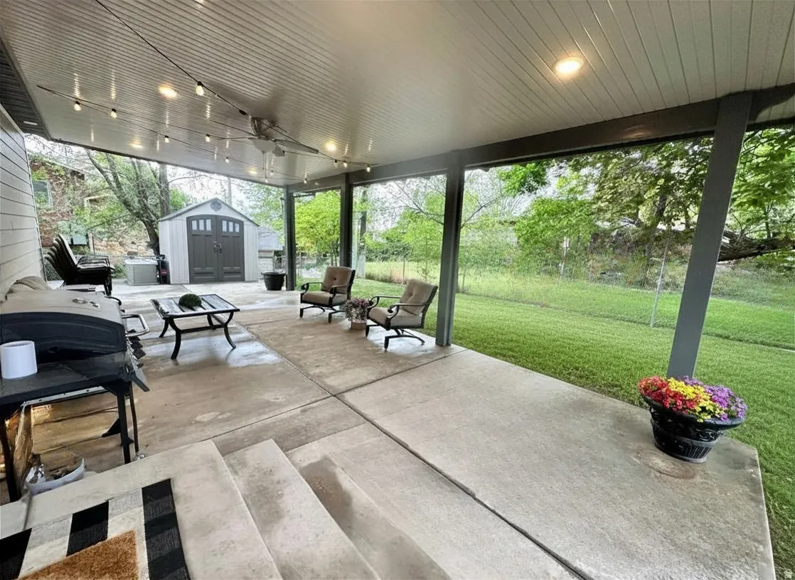 Expansive covered patio featuring string lighting, recessed ceiling lights, and a ceiling fan