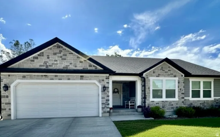Exterior facade featuring varied stone masonry and horizontal siding