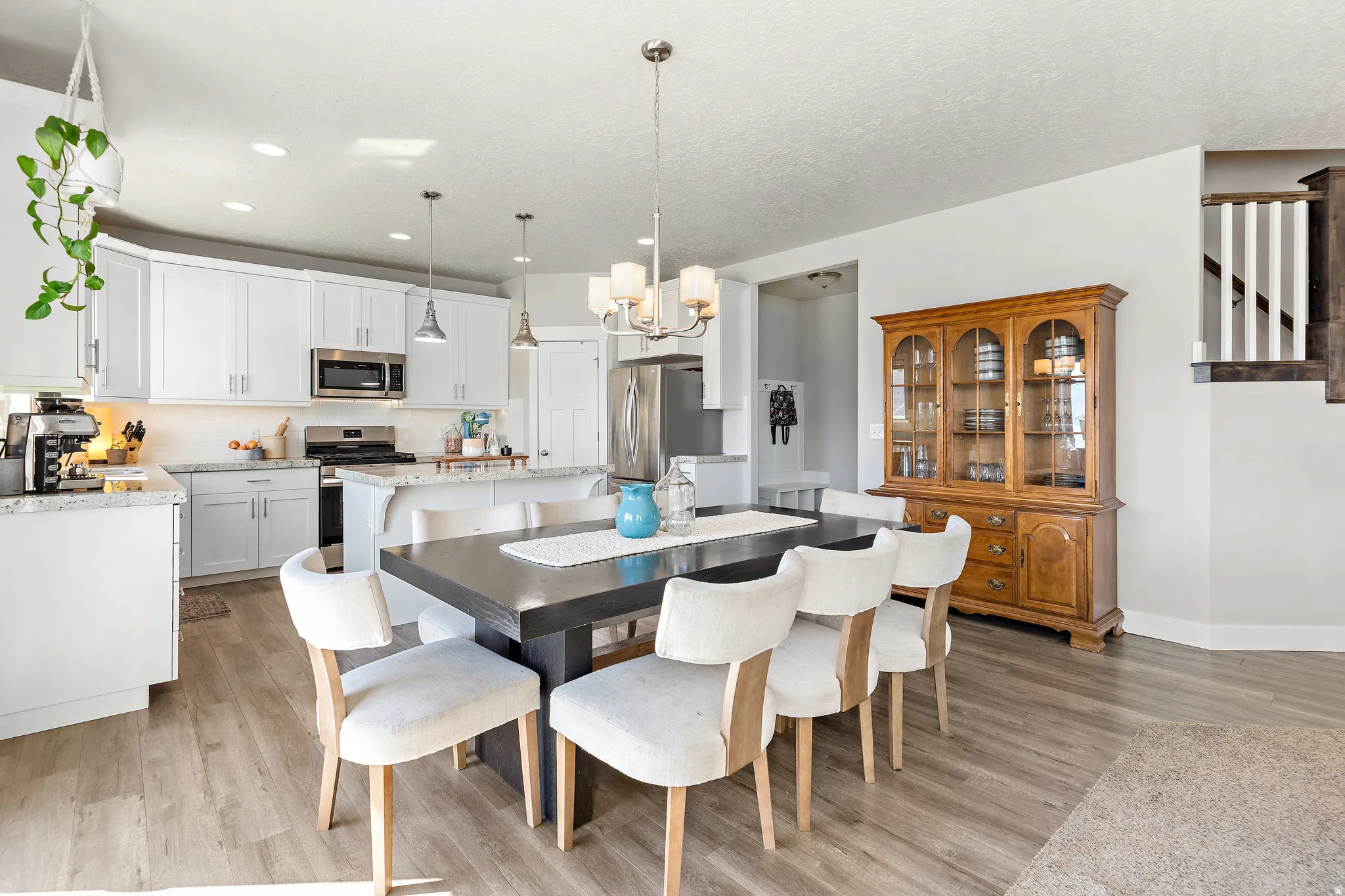 Open-concept kitchen and dining area featuring light wood-finish flooring