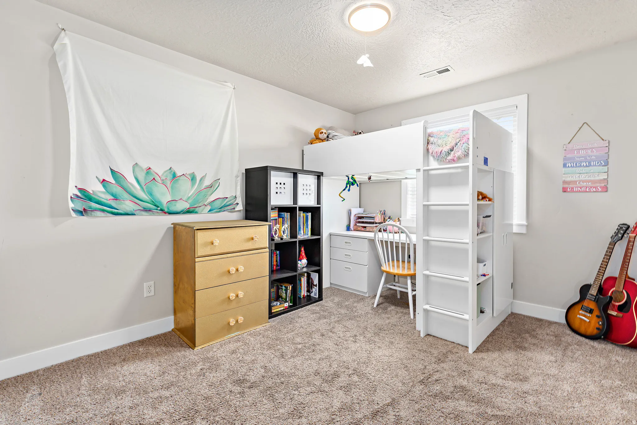 Neutral-toned carpeting spans the floor, complemented by light gray wall paint and white trim