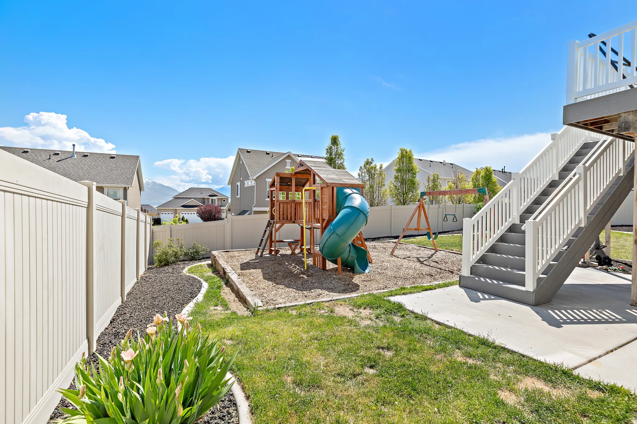 Outdoor patio with concrete slab, white railings, and direct access to the lower level