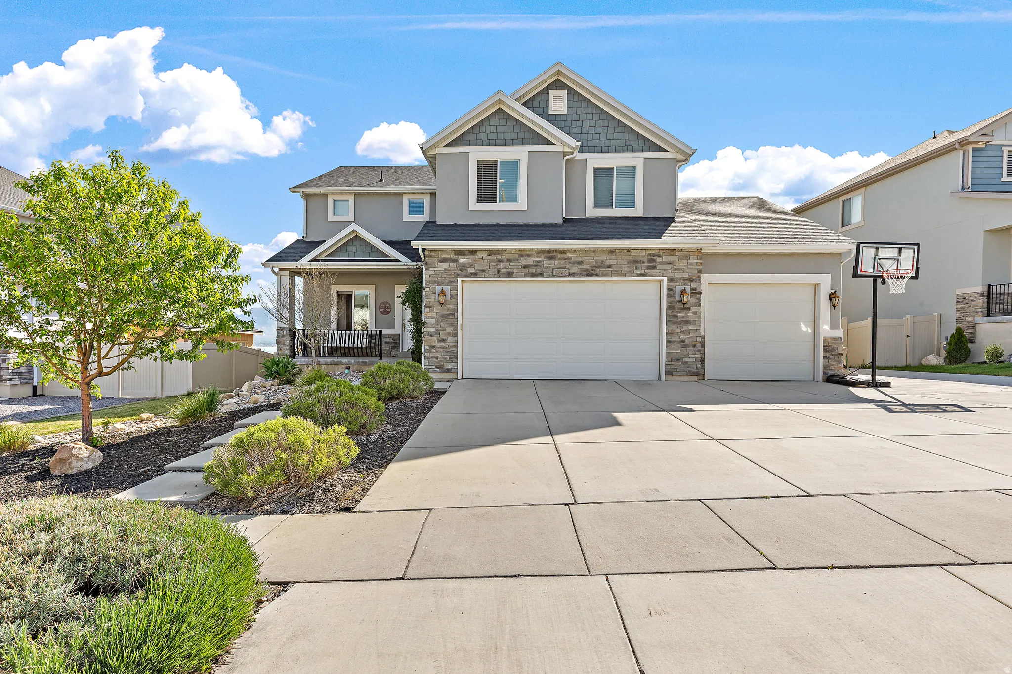 Contemporary two-story residence featuring a combination of stone veneer and stucco siding