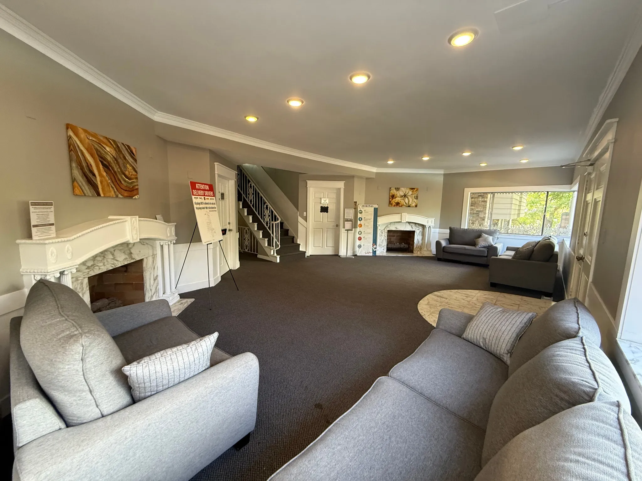 Carpeted living area with a fireplace, crown molding, and recessed lighting