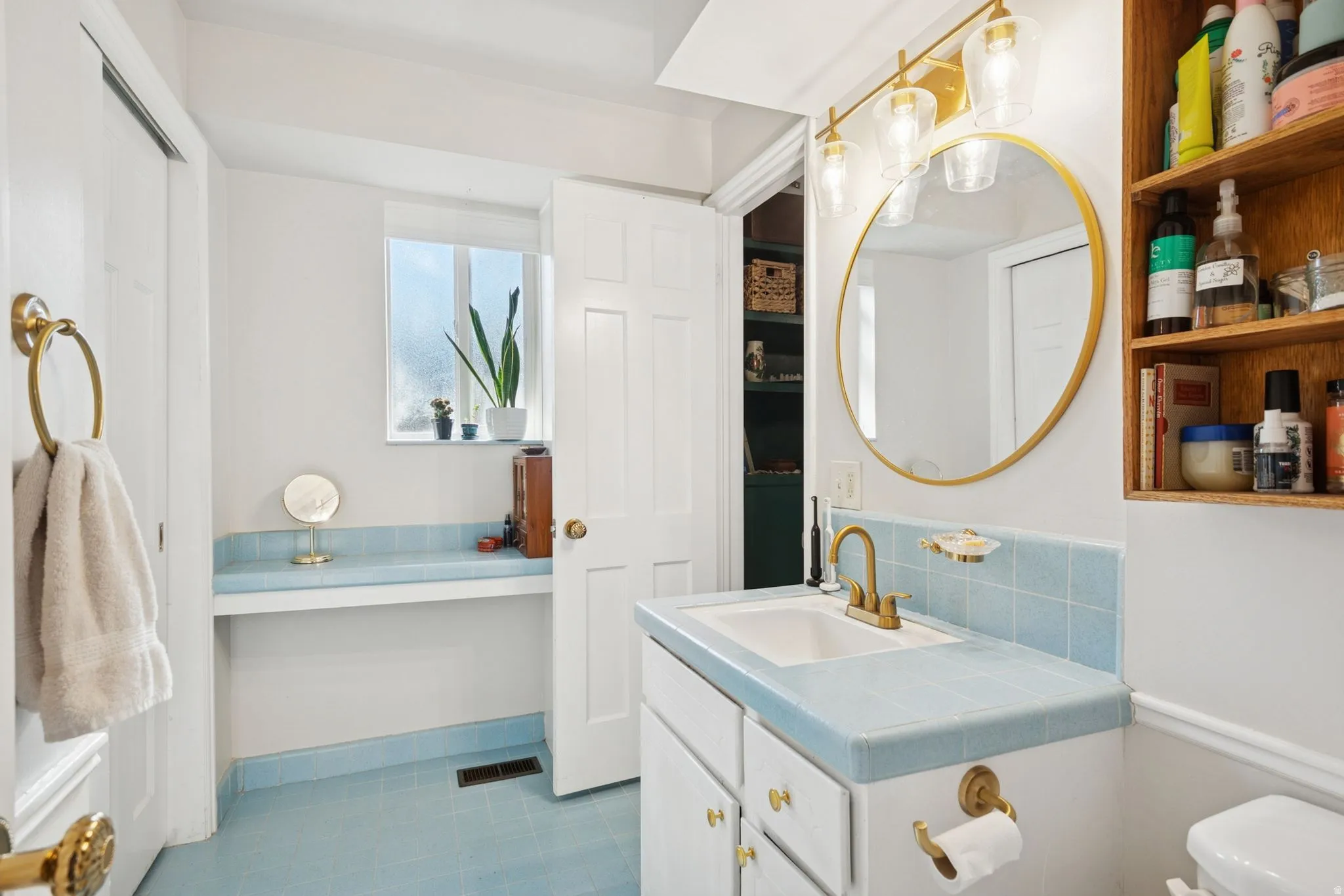 Bathroom featuring vanity and backsplash