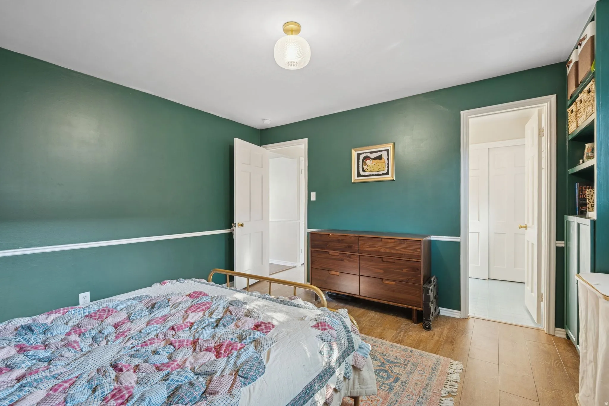 Bedroom featuring light wood-style flooring and baseboards