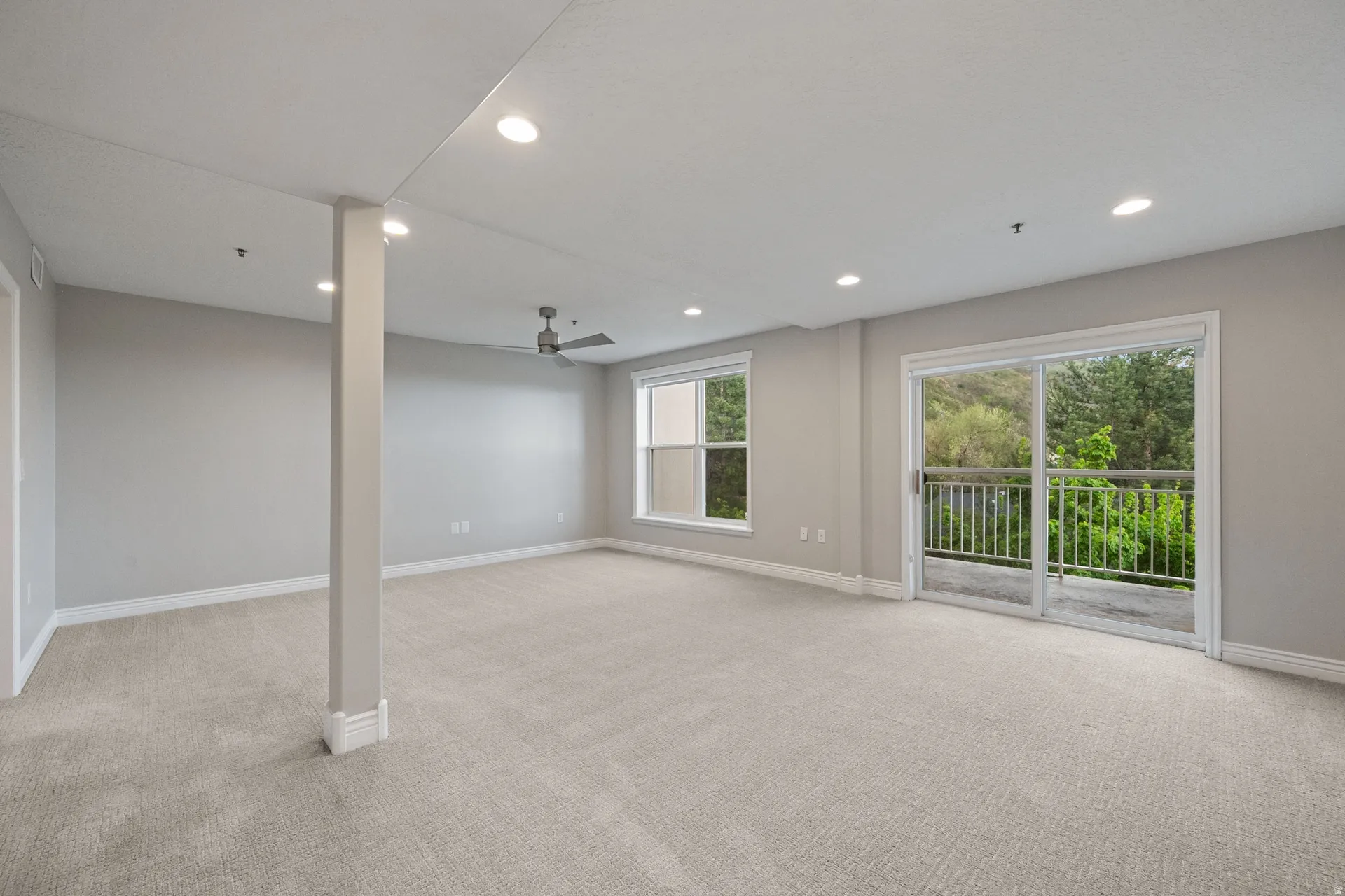 Empty room with light colored carpet, recessed lighting, and a ceiling fan