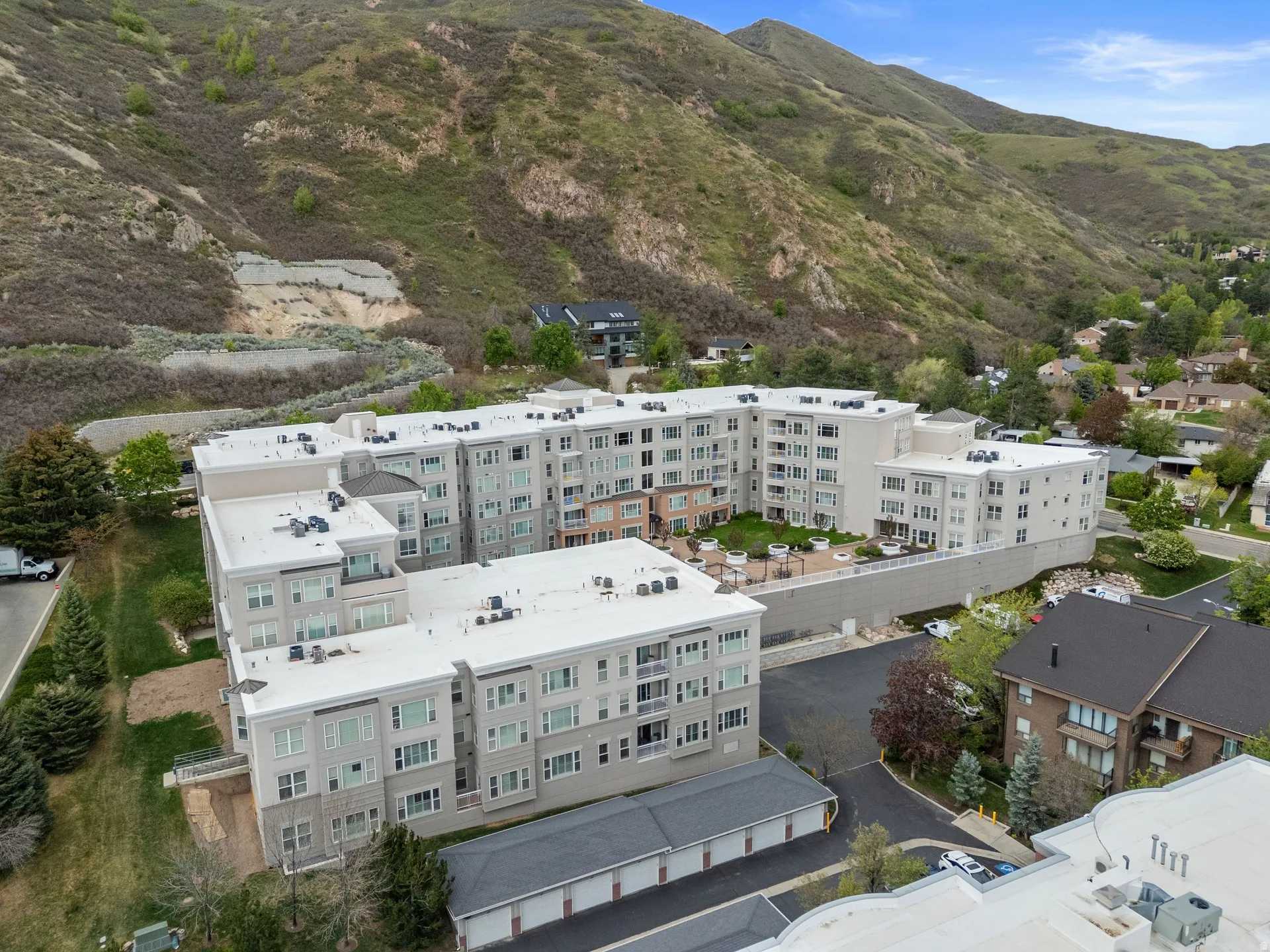Bird's eye view of apartment complex / building and a mountainous background