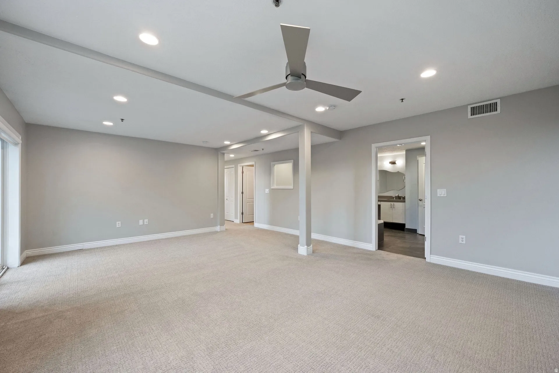 Unfurnished bedroom featuring recessed lighting, light colored carpet, and a ceiling fan