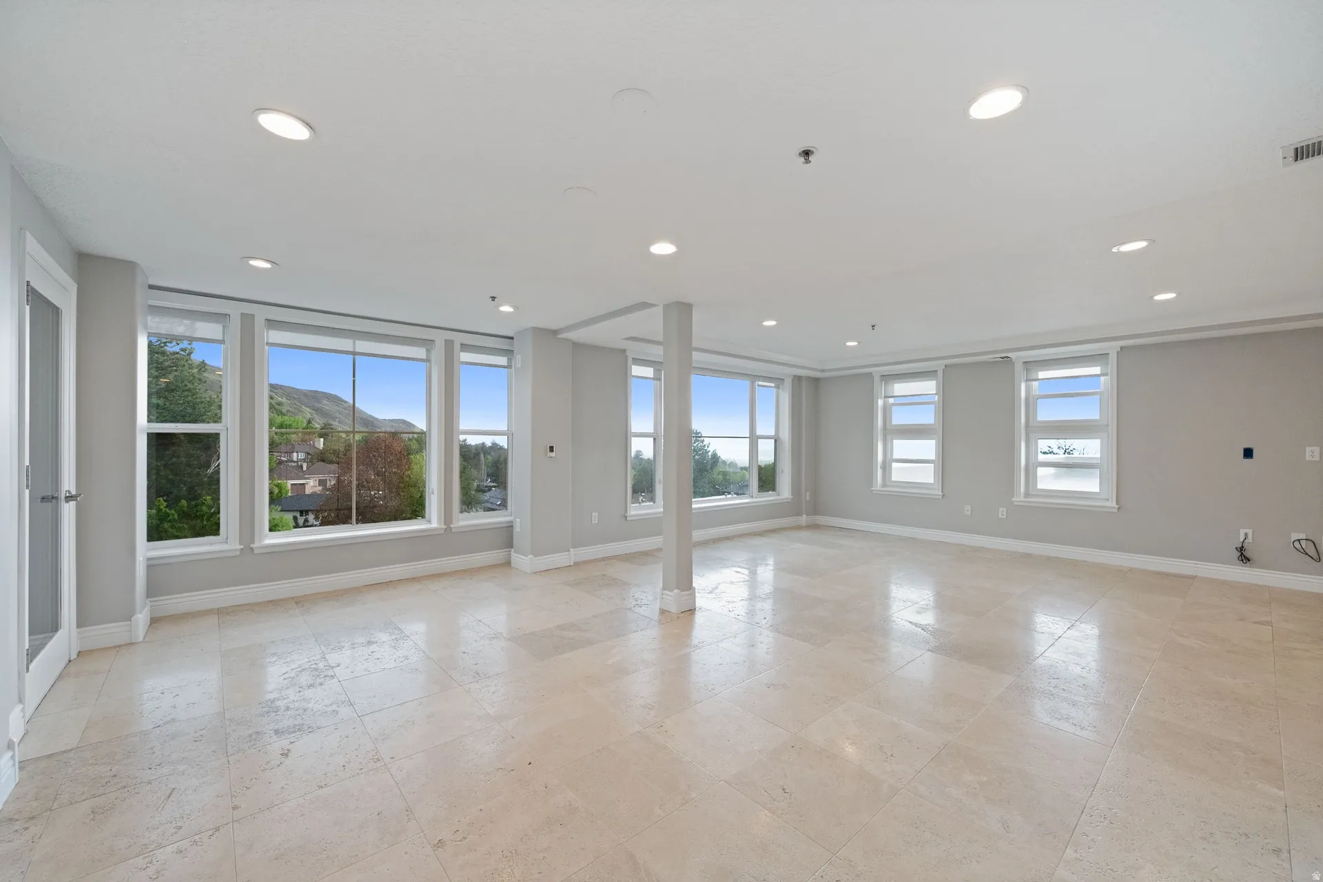 Spare room featuring plenty of natural light, a mountain view, and recessed lighting