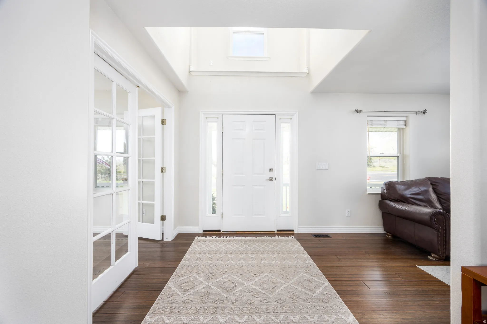 Two-story entryway with wood-finish flooring