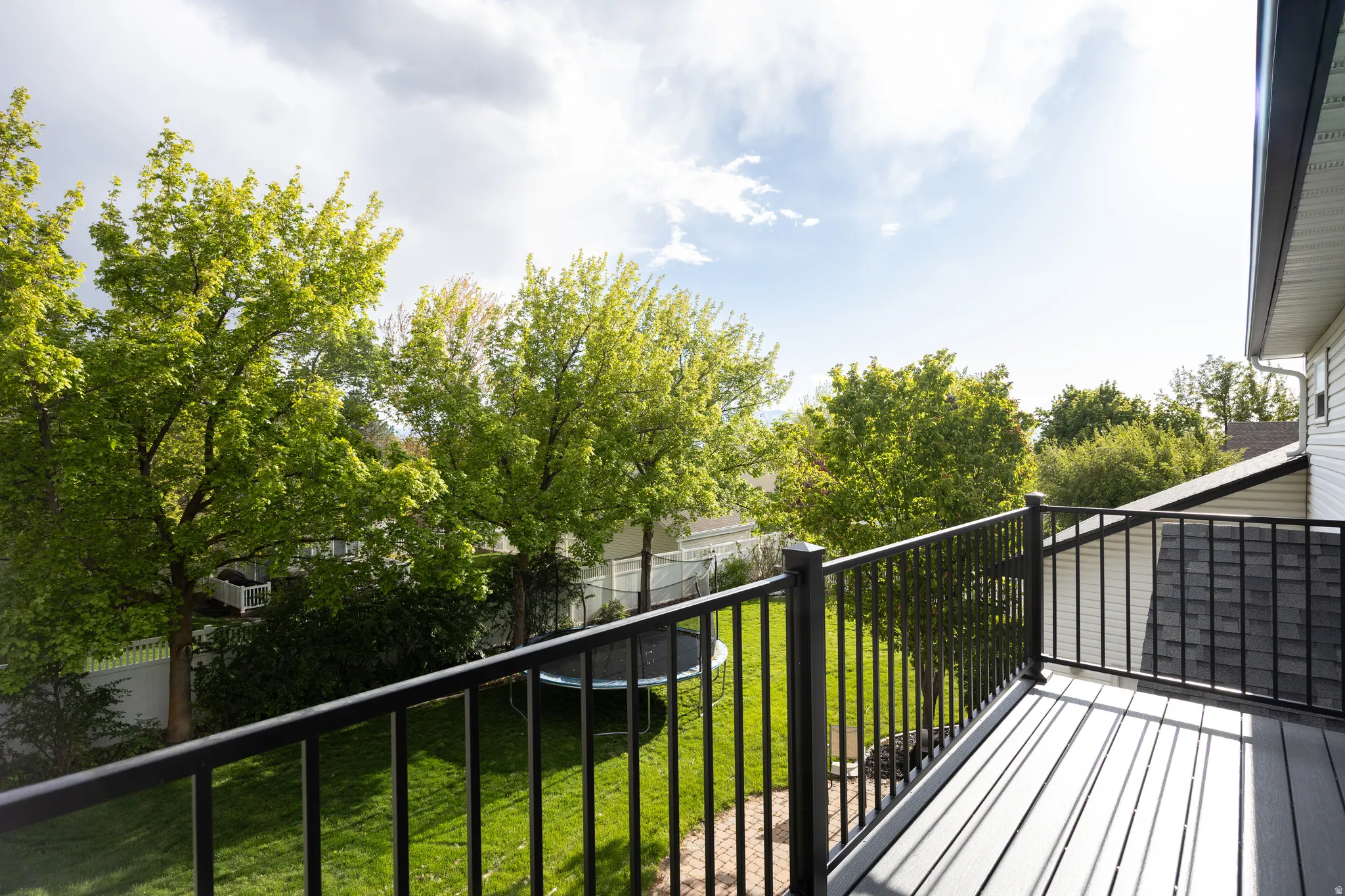Upper-level deck with composite decking and black metal railings