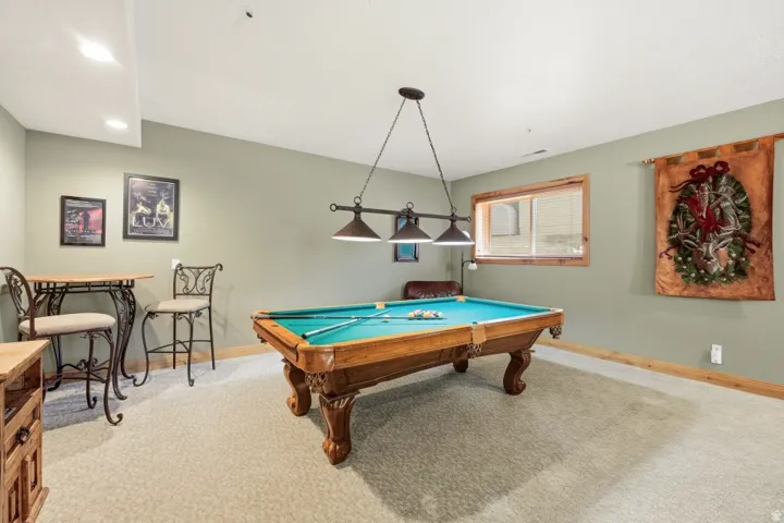 Game room featuring light carpet and pool table