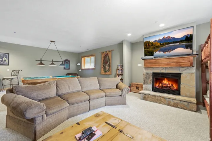 Living area with carpet, a fireplace, billiards table, and recessed lighting