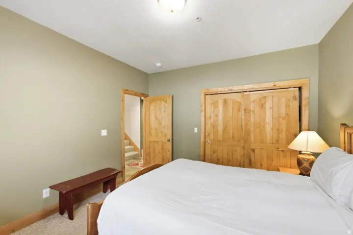 Bedroom featuring a closet and light carpet