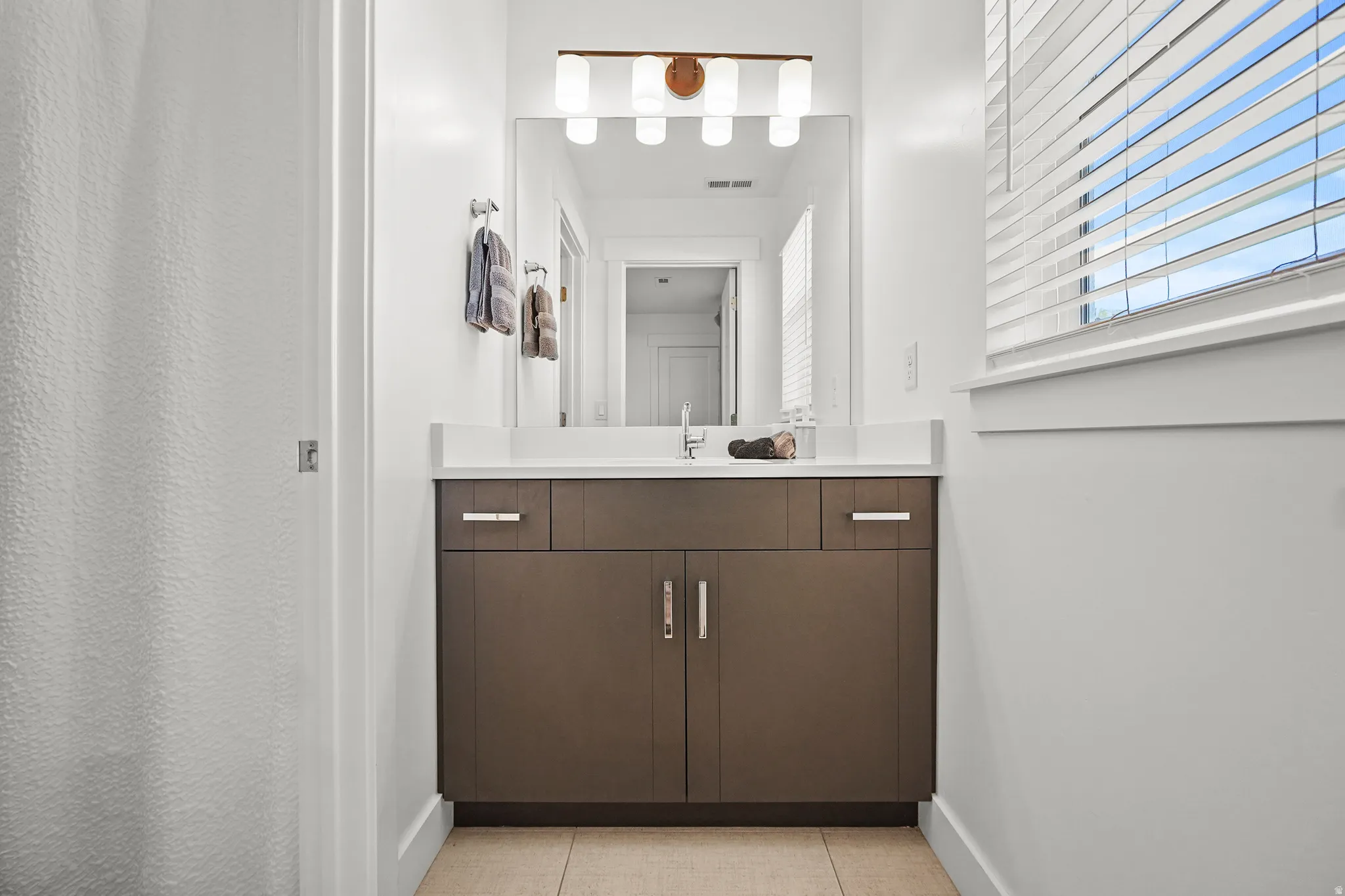 Bathroom with vanity and light tile patterned floors