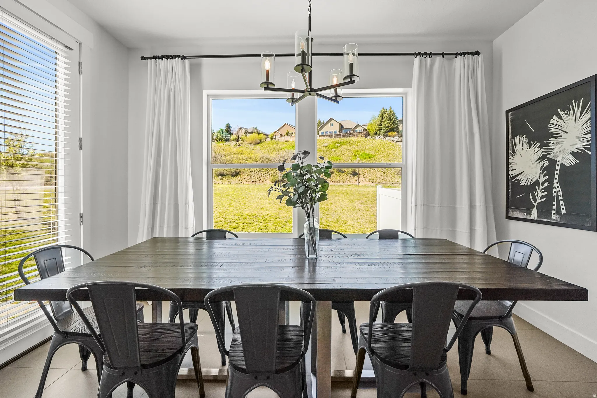 Dining room with tile patterned floors and a chandelier