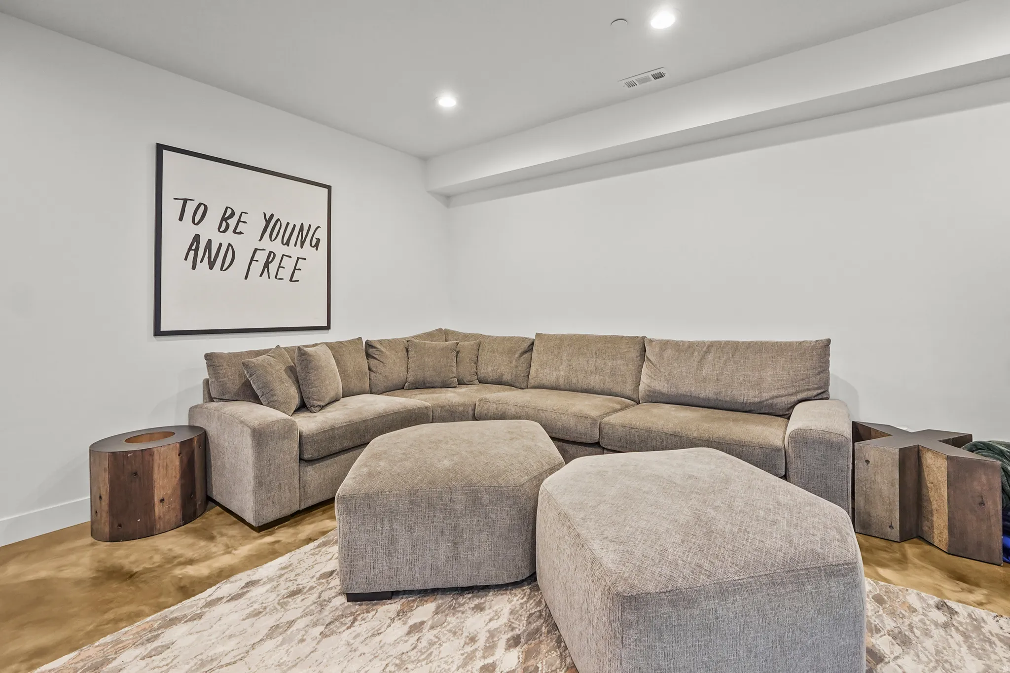 Living area with concrete floors and recessed lighting