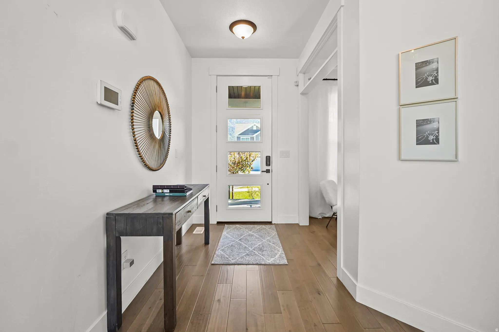 Entrance foyer with baseboards and hardwood / wood-style floors