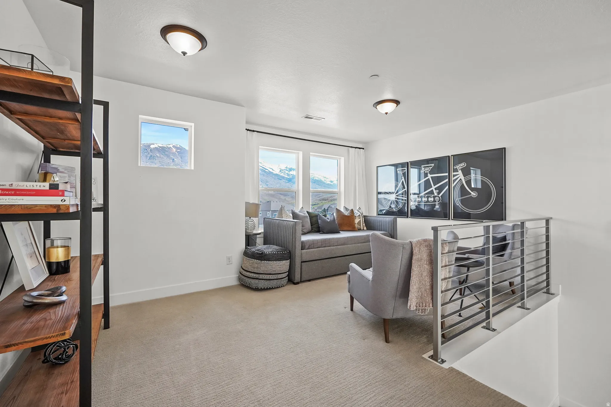 Living area with light carpet and baseboards