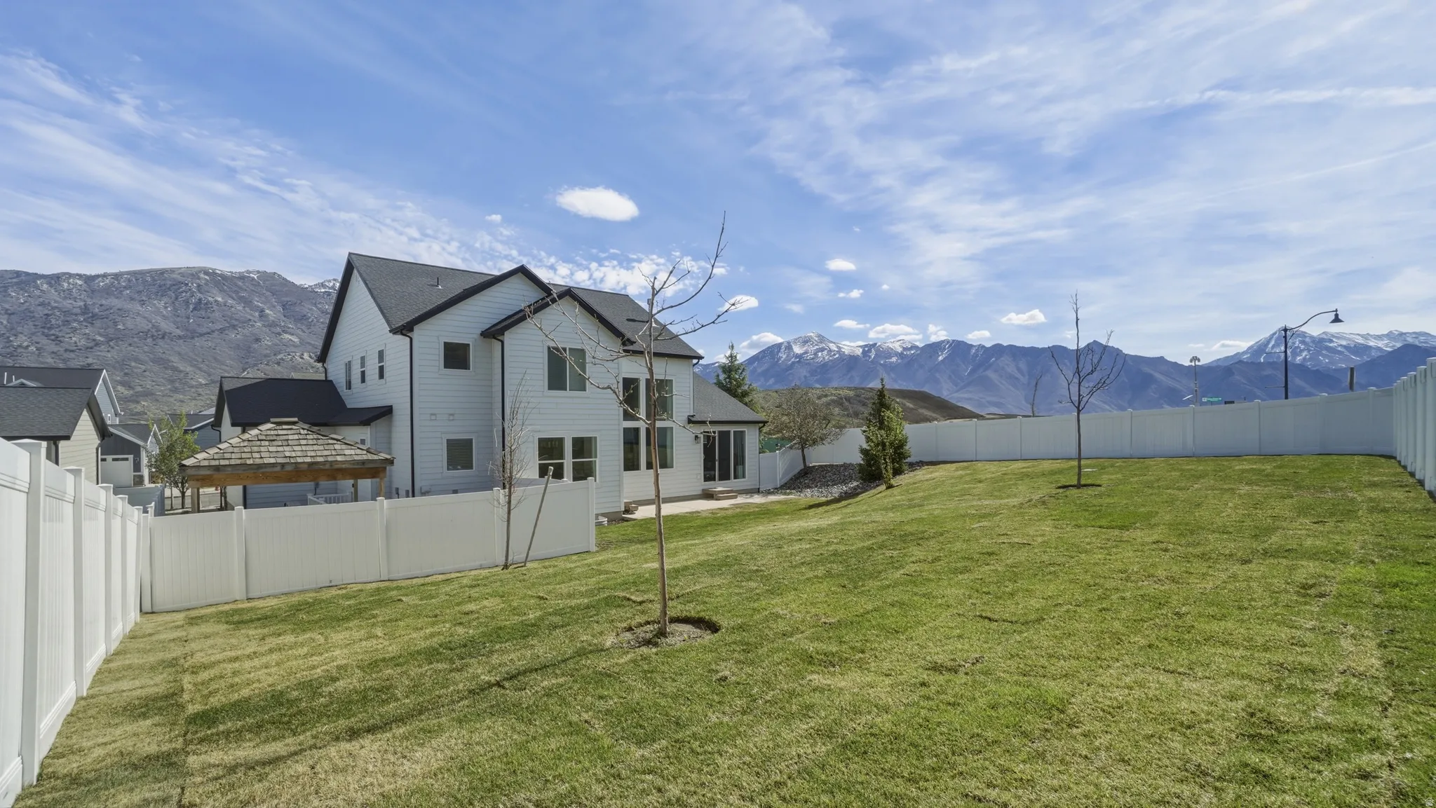 Fenced backyard featuring a mountain view