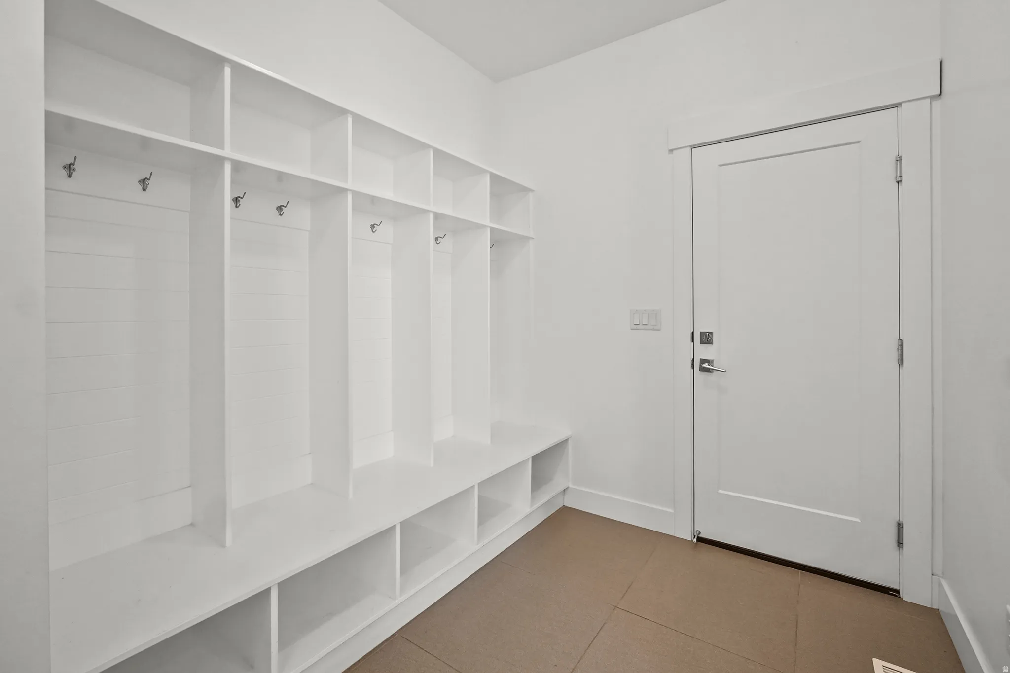 Mudroom featuring light tile patterned flooring and baseboards